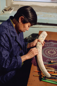 Ljuba Eynes, a well known native artist from Uelen, engraving a piece of walrus ivory. Chukotka, Siberia, Russia. 2004