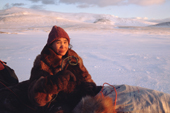 Lema, a Chukchi woman, sits on her sled during a break on a journey by dog team. Uelen, Chukotka, Siberia, Russia. 2004
