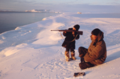 Two Chukchi boys, Larik Vukuchyvun (left) & Matvey Keytegin hunting seals from the snow covered shoreline. Dezhnovka, Chukotka, Siberia. 2004