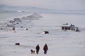 Chukchi hunters walking with their dogs at Dezhnovka. Uelen, Chukotka, Siberia, Russia. 2004