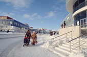 A couple push their child in a pram outside the new shopping centre in Otke Street, Anadyr, Chukotka, Siberia, Russia. 2004