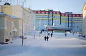 Brightly coloured apartment blocks in the centre of Anadyr surround a boat converted into a bar. Chukotka, Siberia, Russia. 2004