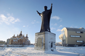 A statue of St Nicholas overlooking the harbour in Anadyr. Behind is the new church & culture centre. Chukotka, Siberia, Russia. 2004