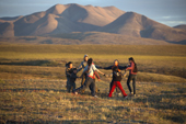 Chukchi children playing outside in evening sunshine at a Chukchi reindeer herder's summer camp. Iultinsky District, Chukotka, Siberia, Russia.