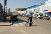 A cyclist crosses the main street in the town of Kasimov. Ryazan Province, Russia. 2006