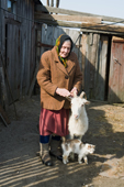 Maria, an elderly woman, at her home in Pogost Village with her goat Rosa, and her cat. Ryazan Province, Russia. 2006