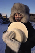 Lena Potapova carrying frozen milk back to her home in Verkhoyansk. Yakutia, Repuiblic of Sakha, Russia. (1999)