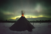 The Northern Lights behind a reindeer herder's camp in Khanty Mansiysk, Western Siberia, Russia. 2000