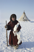 Shurik, a young Tundra Nenets boy poses with an Arctic Hare he has shot. Gydan Peninsula, Western Siberia, Russia. 2000