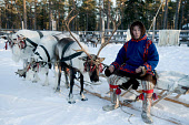 Vassilly Pyak, a Forest Nenets reindeer herder, dressed in traditional winter clothes, sitting on a reindeer sled at his homestead near Numto. Khanty Mansiysk, Northwest Siberia, Russia