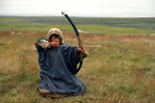 Nenets boy with bow & arrow hunting ptarmigan for the pot on the migration. Yamal. Siberia. Russia.