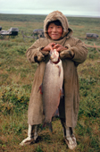 Aleksey Serotetto, a Nenets boy, proudly holds up a Whitefish that he has caught in a tundra lake. Yamal. Siberia. Russia.