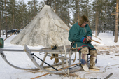 Langu Piak, a Forest Nenets herder, repairs one of his sleds at his winter camp. Purovsky region, Yamal, Western Siberia, Russia.