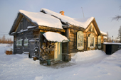 An old wooden house near Yarudey in the winter. Yamal, Western Siberia, Russia