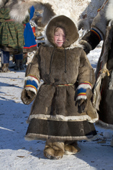 A Nenets girl dressed in reindeer fur clothing at a reindeer herders festival in the Yamal. Western Siberia, Russia