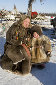 A Nenets mother and daughter dressed in reindeer fur clothing at a reindeer herders festival in the Yamal. Western Siberia, Russia