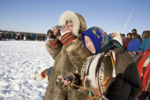 Nenets spectators use their mobile phones to photograph a reindeer race at a herders festival in the Yamal. Western Siberia, Russia