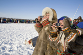 Nenets spectators use their mobile phones to photograph a reindeer race at a herders festival in the Yamal. Western Siberia, Russia