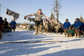 A Nenets man competing in a long jump competition a reindeer herders festival in the Yamal. Western Siberia, Russia