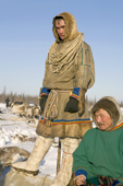 Nenets men watch a native sports competition at a herders festival in the Yamal. Western Siberia, Russia
