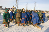 Nenets spectators watch a trial of strength competition at a herders festival in the Yamal. Western Siberia, Russia