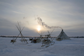 A Nenets reindeer herders winter camp at sunrise in the Yamal. Western Siberia, Russia.