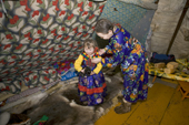 Ustinya Laptander with her daughter Yaline, in a reindeer skin tent at their winter camp in the Yamal. Western Siberia, Russia