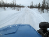 View from the cab of a Ural truck travelling on a winter road in the Yamal. Western Siberia, Russia