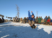A Nenets man competing in a long jump competition at a reindeer herders festival in the Yamal. Western Siberia, Russia