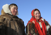 A Nenets man and woman in traditional dress at a reindeer herders festival in the Yamal. Western Siberia, Russia