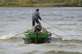 Khanty fishermen taking their budarka (boat) out in bad weather on the River Ob. Western Siberia.