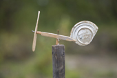 An improvised weather vane made from drift wood and a can at a Khanty fishing camp on the River Ob. Western Siberia