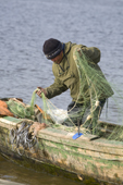Arkhip Tokhma, A Khanty fisherman, preparing nets in his Budarka (boat) on the River Ob. Yamal, Western Siberia, Russia