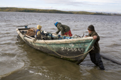 A Khanty couple prepare to go fishing in their Budarka (boat) on the River Ob near Aksarka. Yamal, Western Siberia