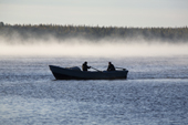 Khanty fishermen out fishing in their Budarka (boat) on a misty morning on the River Ob near Aksarka. Yamal, Western Siberia
