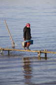 Lidiya Tokhma, a Khanty woman, collecting water at a fishing camp on the river Ob near Aksarka. Yamal, Western Siberia, Russia