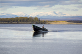A Budarka (fishing boat) on the River Ob near Gornoknyazevsk with the Ural Mountains in the background. Yamal, Western Siberia, Russia