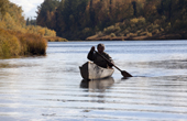 On an autumn day, Gennadiy Kubolev, a Selkup man, returns from fishing in his 'Anty' (traditional dugout boat) on the River Shirta. Krasnoselkup, Yamal, Western Siberia, Russia