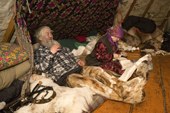 Ivan Taibery and his wife Yevdekiya, an elderly Nenets couple, inside their reindeer skin tent at a winter camp. Yamal, Western Siberia, Russia