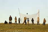 Nenets children, well covered up against mosquitoes, playing volleyball at a fishing camp on the Yuribey River.The net is made from a fishing net. Gyda, Tazovsky Region, Gydan Peninsula, Yamal, Siberia