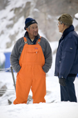 An Inuit fishermen chatting in the harbour at Ilulissat. West Greenland