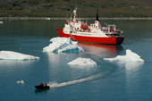 A zodiac heads for shore after leaving a tourist ship in the Disko Bay. West Greenland.