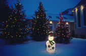 An illuminated snowman forms part of Christmas display  outside a home in Winnipeg. Manitoba. Canada Canada.
