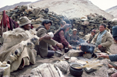 Yak herders cook a meal over an open fire at their camp. Ladakh, India