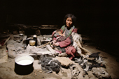 Yak herder's wife nurses her baby in a stone shelter. Ladakh. India.